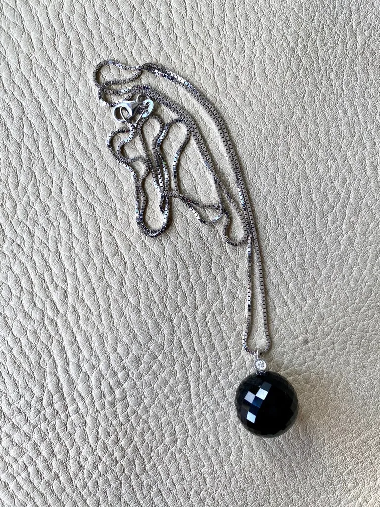 Brilliant! Black onyx faceted orb pendant necklace set in 18k white gold with 0.05 ct brilliant cut diamond by Ole Lynggaard