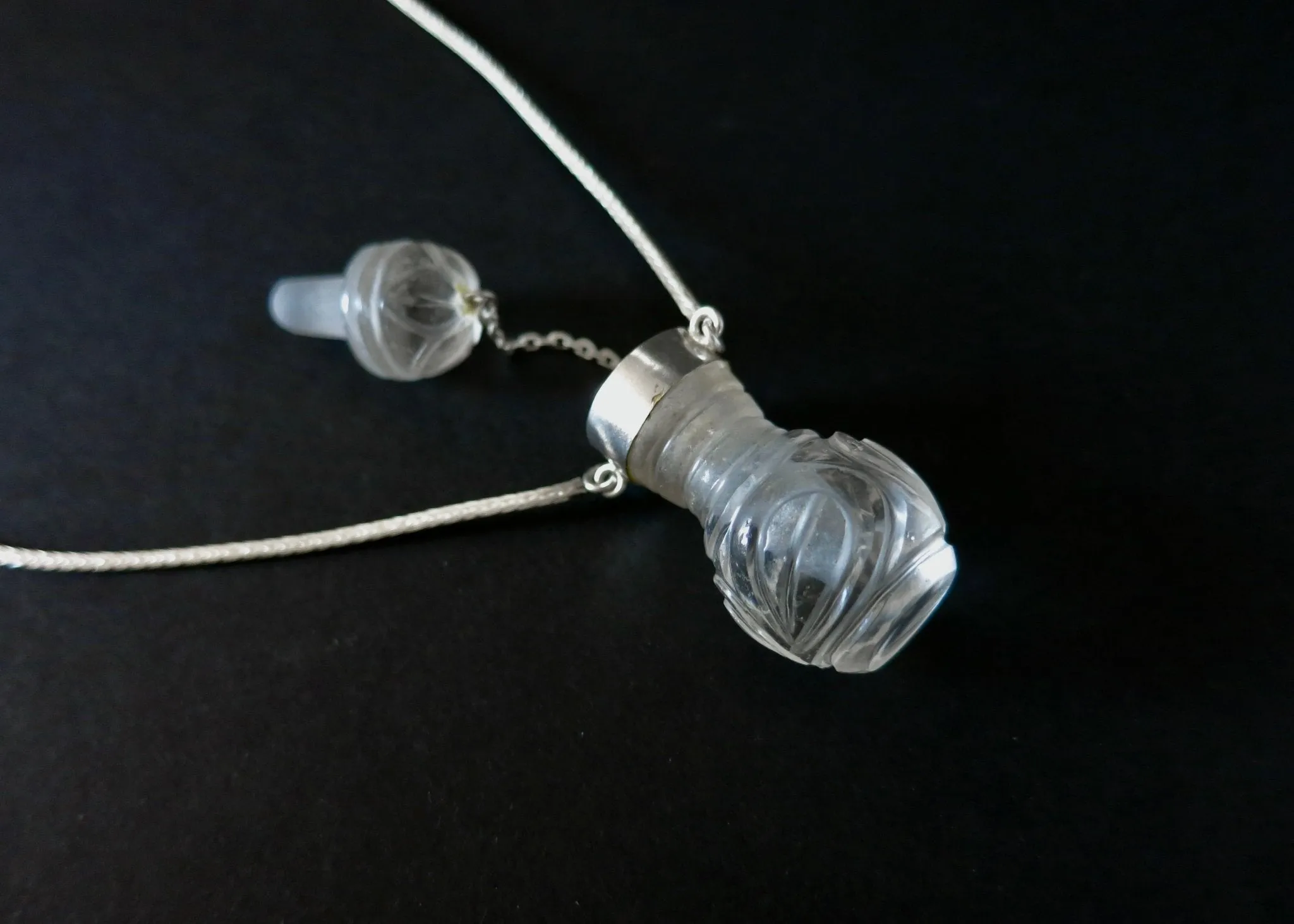 Rare, collectible, hand-carved rock crystal perfume bottle with a handmade chain