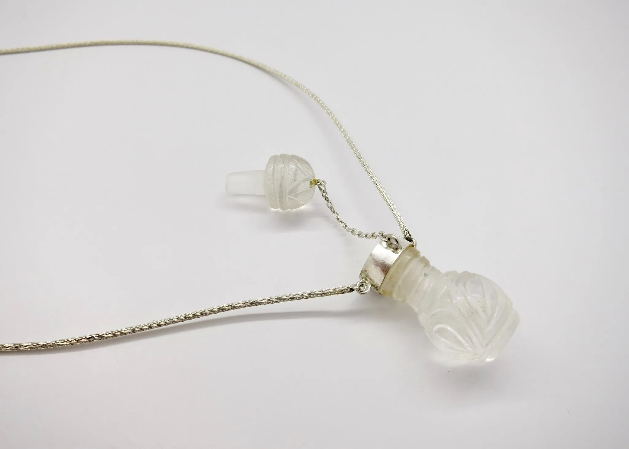 Rare, collectible, hand-carved rock crystal perfume bottle with a handmade chain