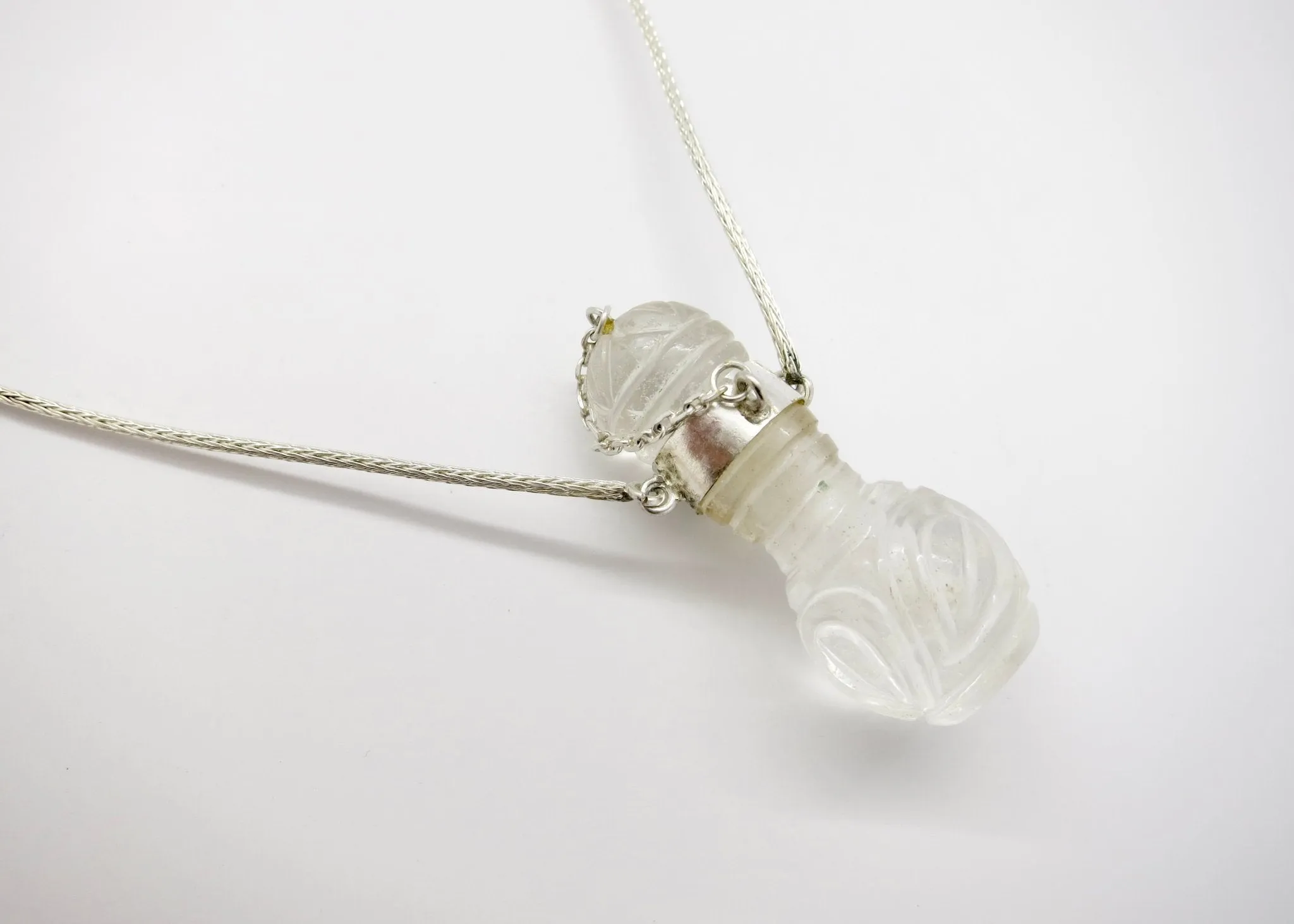 Rare, collectible, hand-carved rock crystal perfume bottle with a handmade chain